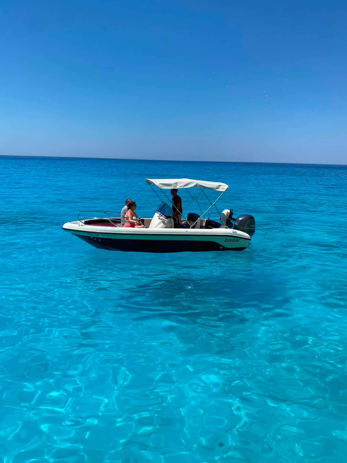 Mateo floating on electric blue water