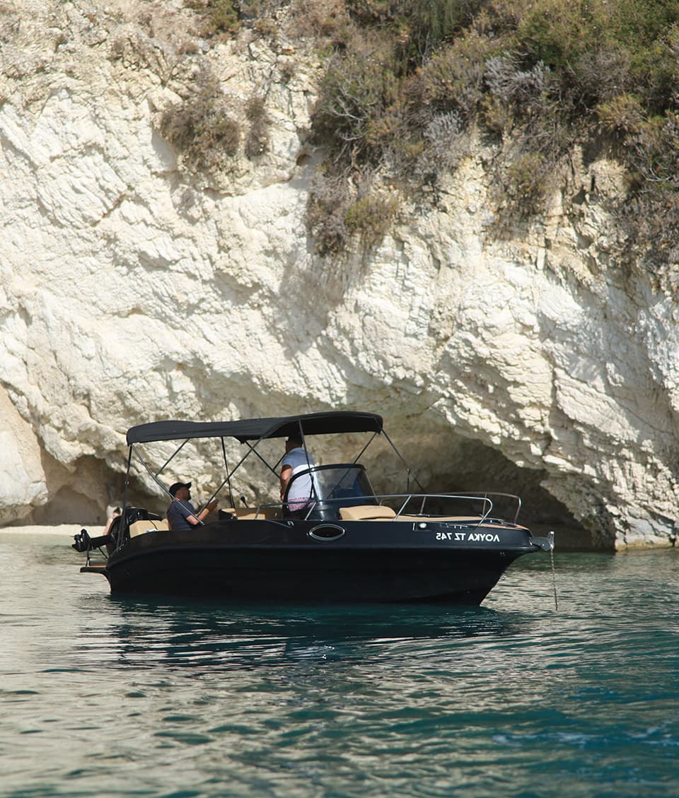 Loukas speedboat moored by the white cliffs of Zakynthos