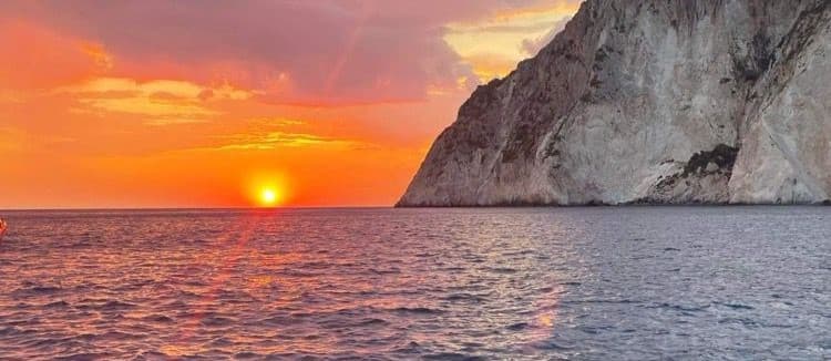 Golden sunset over the Zakynthos cliffs seen from a boat