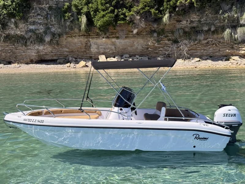 Mateo, our self-drive motorboat, moored on clear turquoise water in Zakynthos
